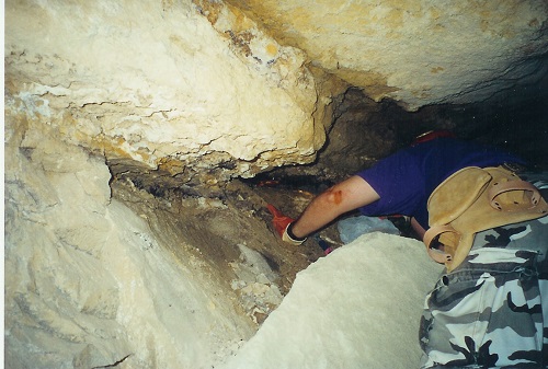 8.) Mark Easterbrook looking for yellow fluorite in the adit behind the mine pillar.