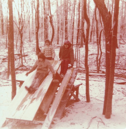 Sliding down an ice-coated picnic table. I'm wearing Aunt Ruth's knitted sweater.
