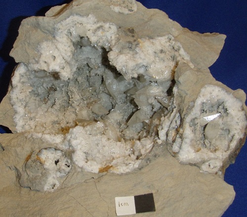 A large, complex geode with calcite in Salem Limestone, from Salem Quarry in Washington Co., Indiana. Crystals are sharp scalenohedrons. 