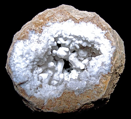 Milky Quartz in large crystals. The white color is due to microscopic inclusions of water and/or gas bubbles, like CO2. The 6 cm wide geode is from Monroe Co., Indiana. Bob Harman specimen and photo.