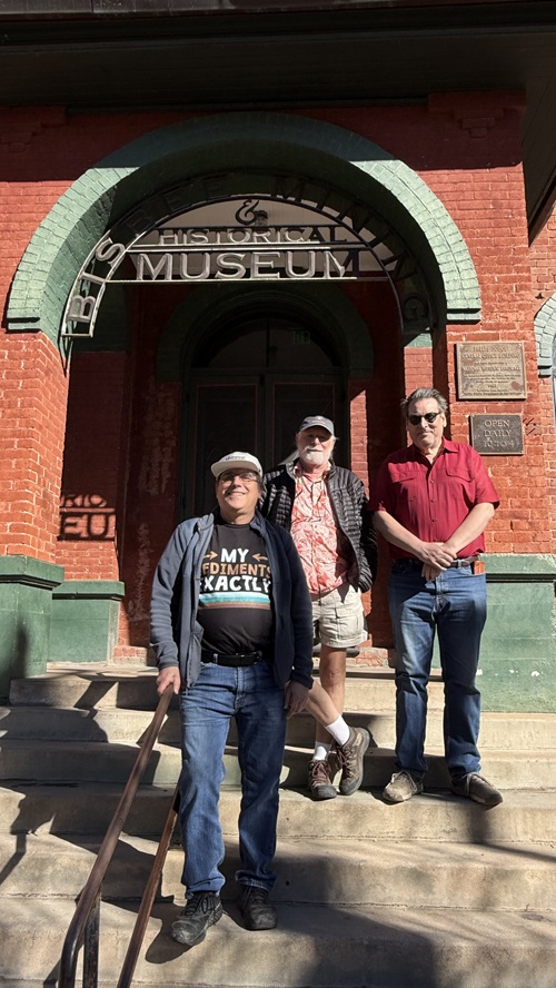 Alan Goldstein, Ed Jacoby, and Dave Eicher stand at the entrance to the museum.