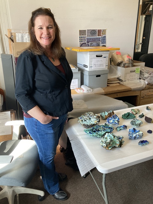 Annie Larkin, the museum director, and I stand with the KSC minerals in the two rows between us. The other minerals are from their collections.