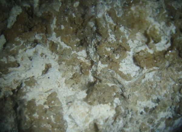 Photo HZ1, White hydrozincite with brown cerussite crystals from the Hickory Cane mine. FOV = 3 cm