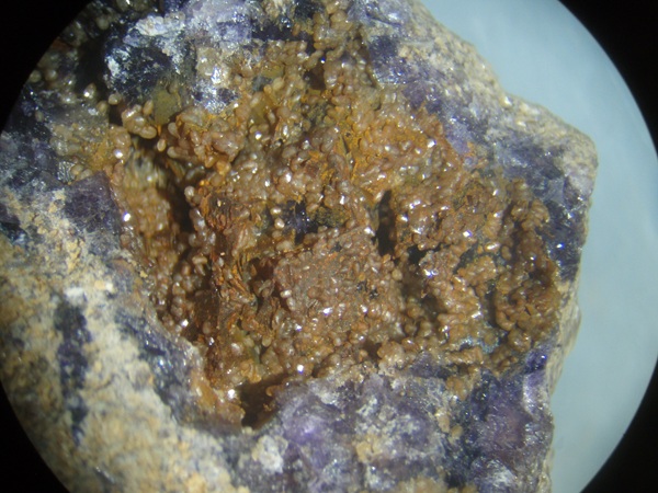 Photo Sm6, Smithsonite in brown crystals on fluorite from the Hastie's Quarry, collected in May 2001.