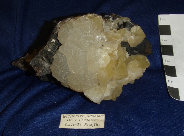 Photo Wi1, Witherite, in a tan complex crystal cluster on etched yellow fluorite and large sphalerite crystals, Minerva No. 1 mine.