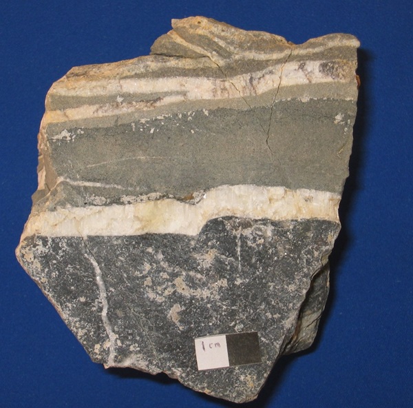 Photo Aln2, Hutson dike with calcite veins and limestone wall rock on the bottom.