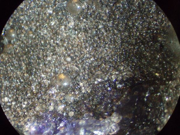 Calcite and fluorite spheres (pseudomorphs after bubbles) from Hastie's Quarry, collected in 1984. See "Hydrocarbons" for more information. FOV = 1 cm