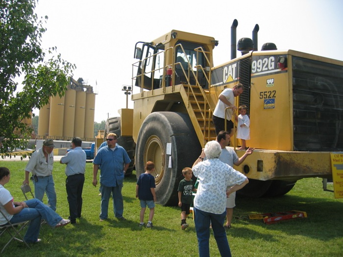 Front-end loader with people for scale. 
