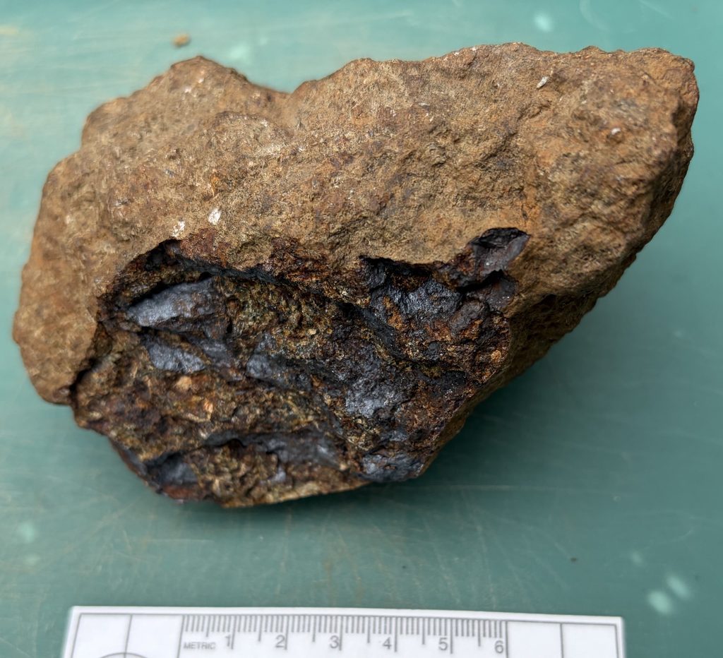 Mystery rock from the Sterling Hill mine collecting pile. My guess: bluish-black is chalcophanite and the yellow is meionite (because it fluoresces magenta). Stay tuned!