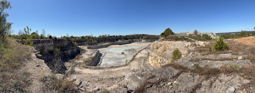 Panoramic photo of the main quarry from the northeast corner. The track hoe is removing a shale bed from the quarry floor.